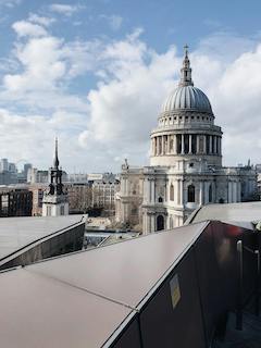 A majestic view of St. Paul's Cathedral in London, showcasing its iconic dome, intricate stonework, and surrounding cityscape