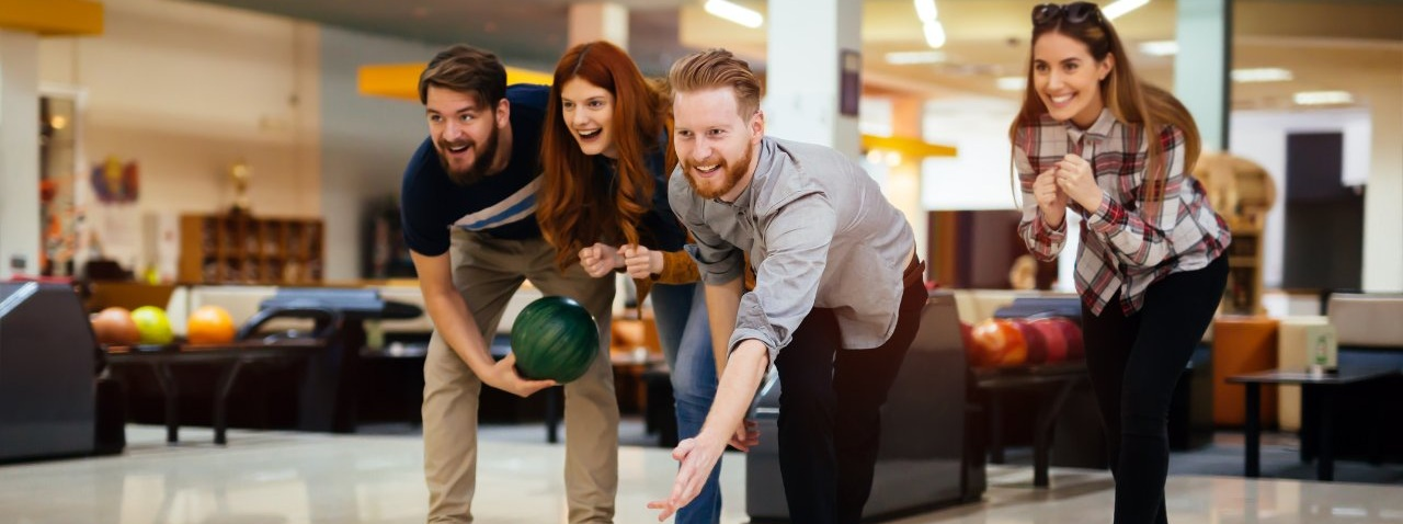 A young couple stands side-by-side on a bridge, gazing out at the iconic London skyline. Big Ben and the Houses of Parliament are visible in the distance